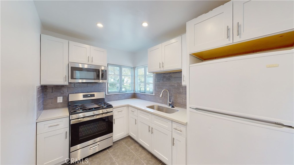 526 North Madison Avenue Pasadena, CA 91101 - Photo 11 of 21 a kitchen with white cabinets and white appliances