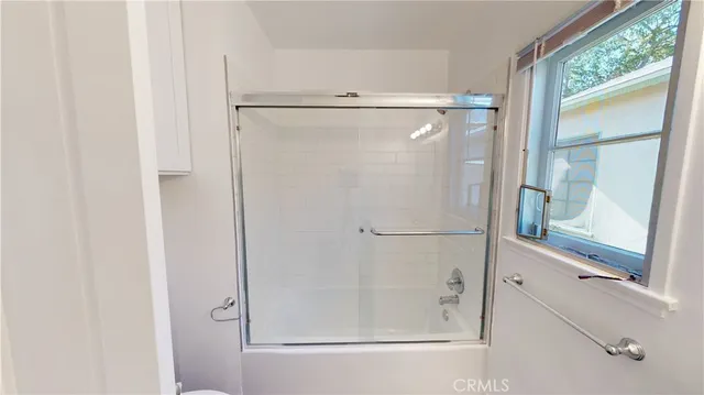 a bathroom with a glass shower door