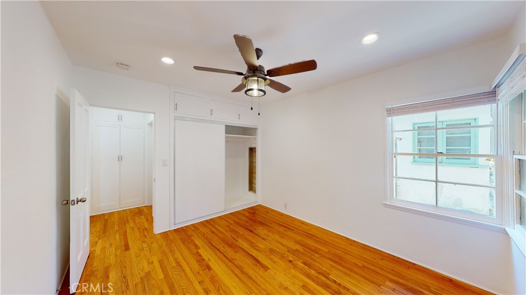 526 North Madison Avenue Pasadena, CA 91101 - Photo 13 of 21 a view of a bedroom with wooden floor and a ceiling fan