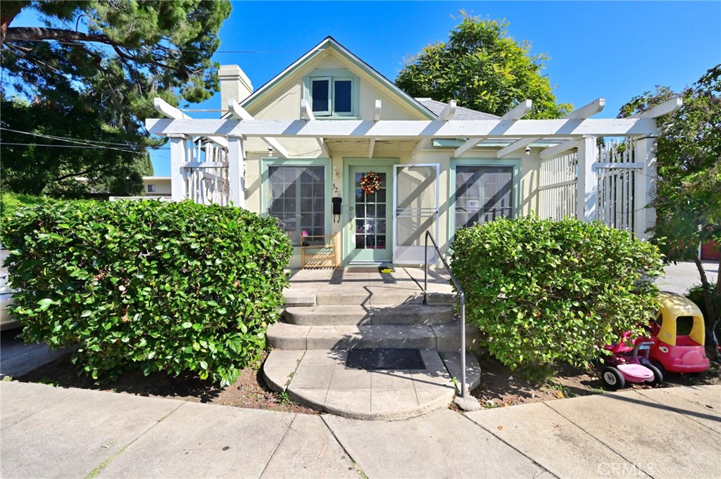 526 North Madison Avenue Pasadena, CA 91101 - Photo 6 of 21 a view of a white house with large windows and a flower garden