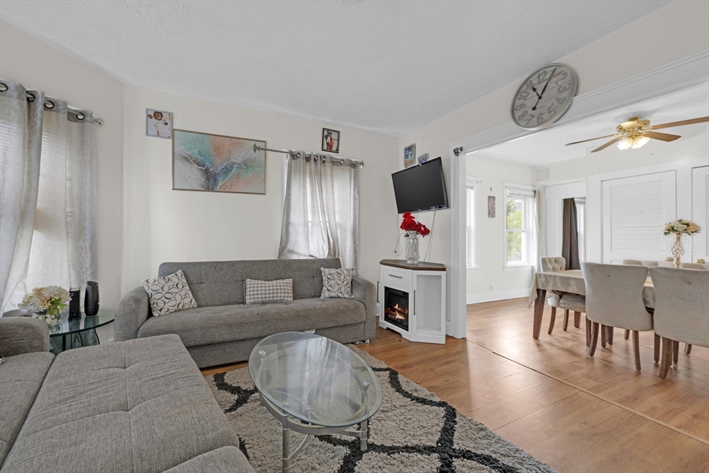29 Whitcomb Street Webster, MA 01570 - Photo 13 of 17 a living room with furniture a fireplace and a flat screen tv