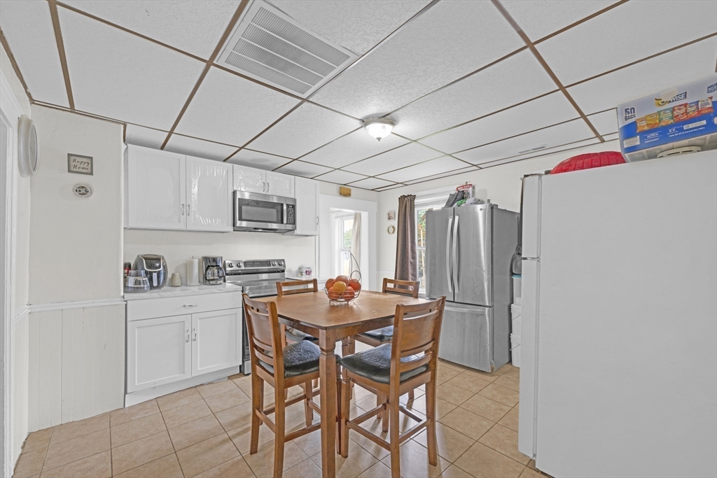 29 Whitcomb Street Webster, MA 01570 - Photo 15 of 17 a dining room with stainless steel appliances a table and chairs