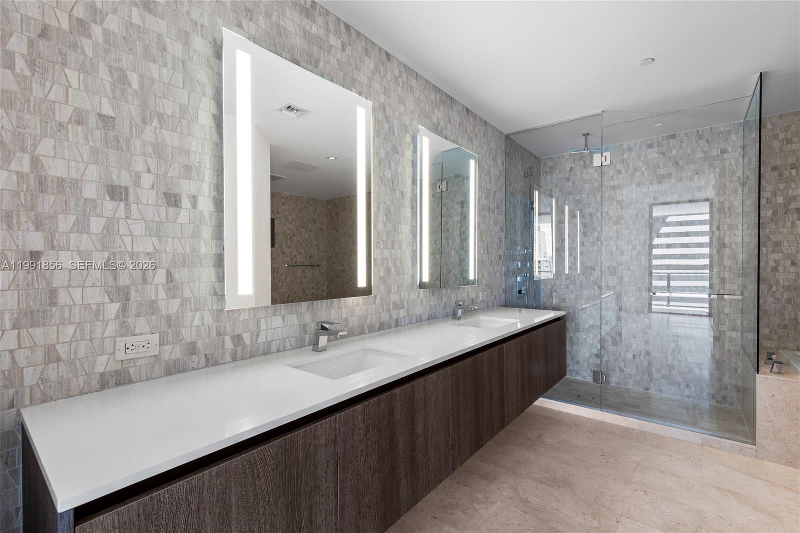 a bathroom with double sink and a mirror