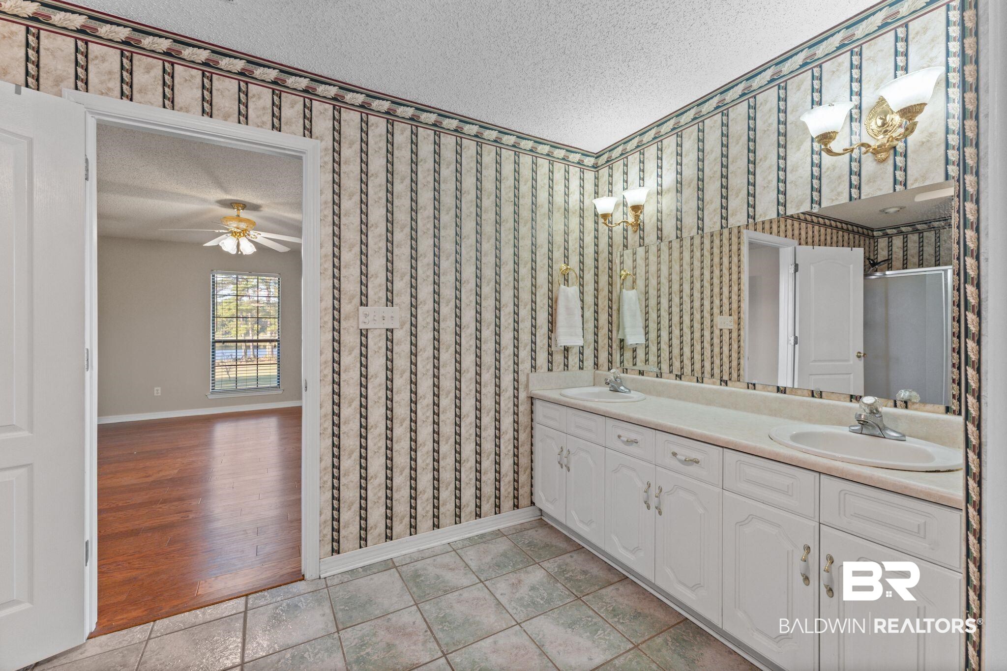 888 Mobile Cut-Off Road St. Stephens, AL 36569 - Photo 24 of 54 Full bath featuring light tile patterned floors, a textured ceiling, double vanity, and a shower stall