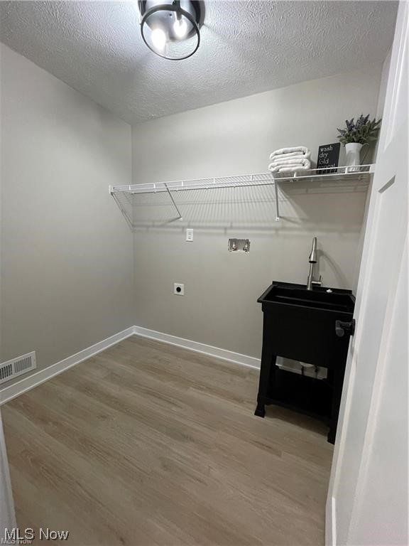 7374 Crossfield Road Mentor, OH 44060 - Photo 30 of 35 Second floor laundry room featuring light hardwood floors