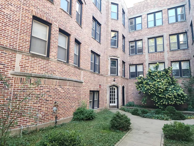 a view of a building next to a yard