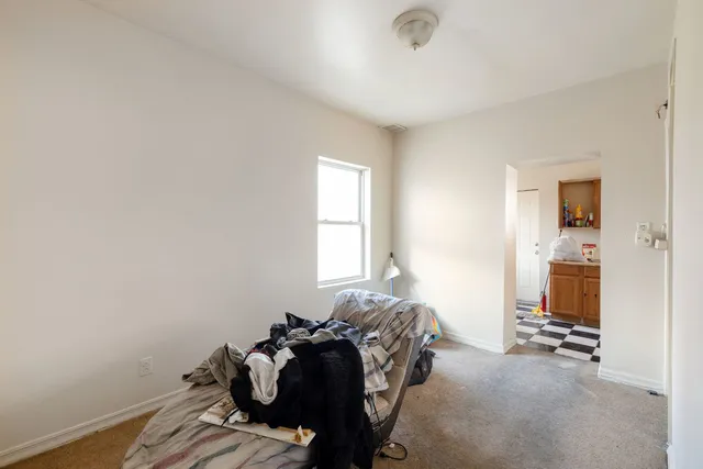 a bed room with a bed and a window