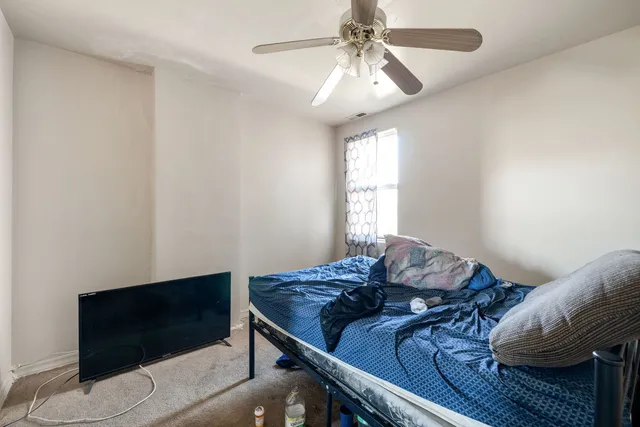 a view of a livingroom with furniture and a ceiling fan