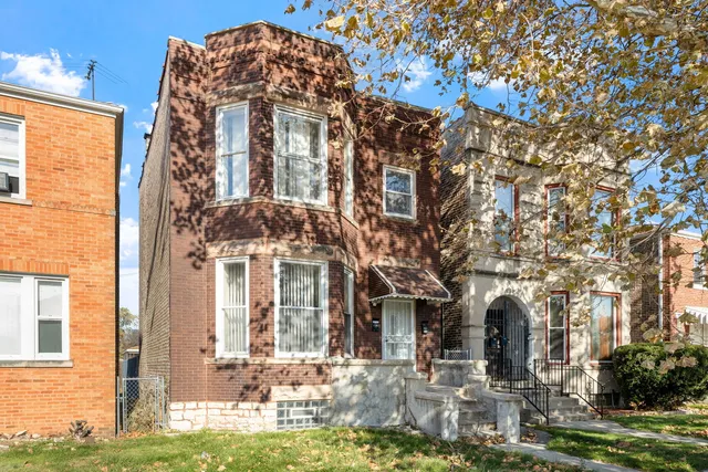 a front view of a building with a yard