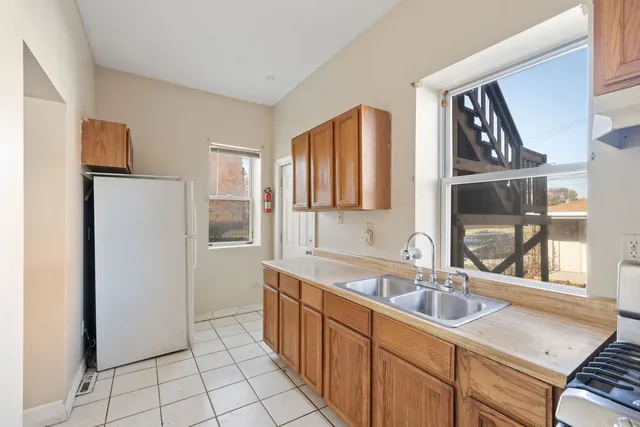 a kitchen with a sink and a refrigerator