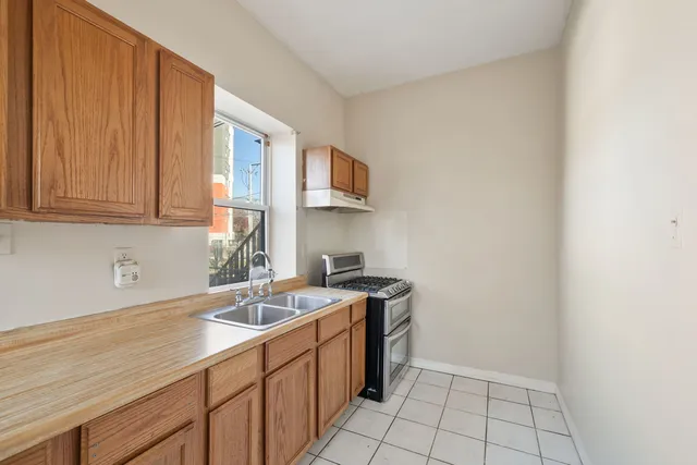 a kitchen with a sink cabinets and utility