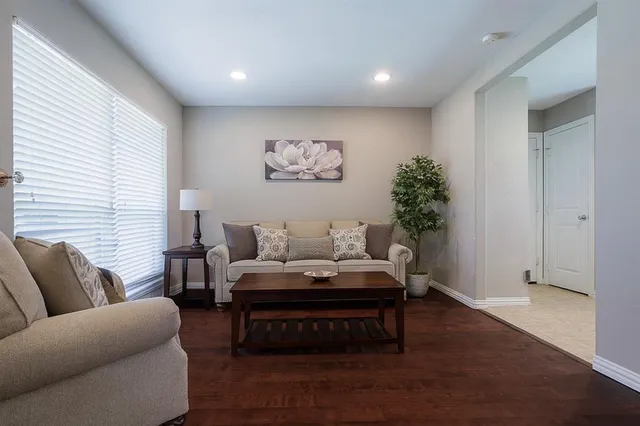 a living room with furniture and wooden floor