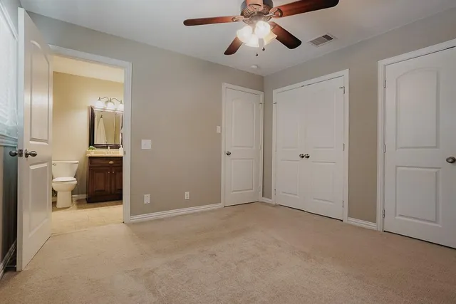wooden floor in an empty room and a bathroom