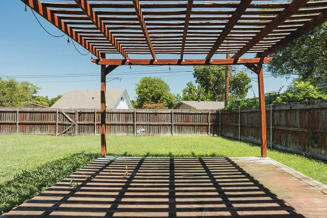 a view of a backyard with wooden fence