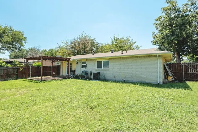 a view of a backyard with a garden and entertaining space