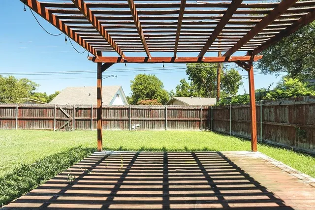a view of a backyard with wooden fence