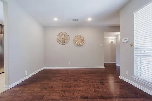 a view of a room with wooden floor