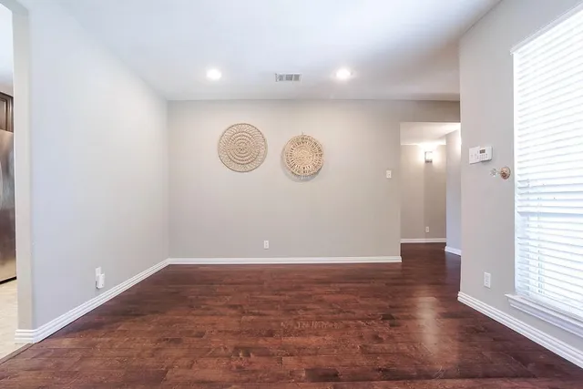a view of a room with wooden floor
