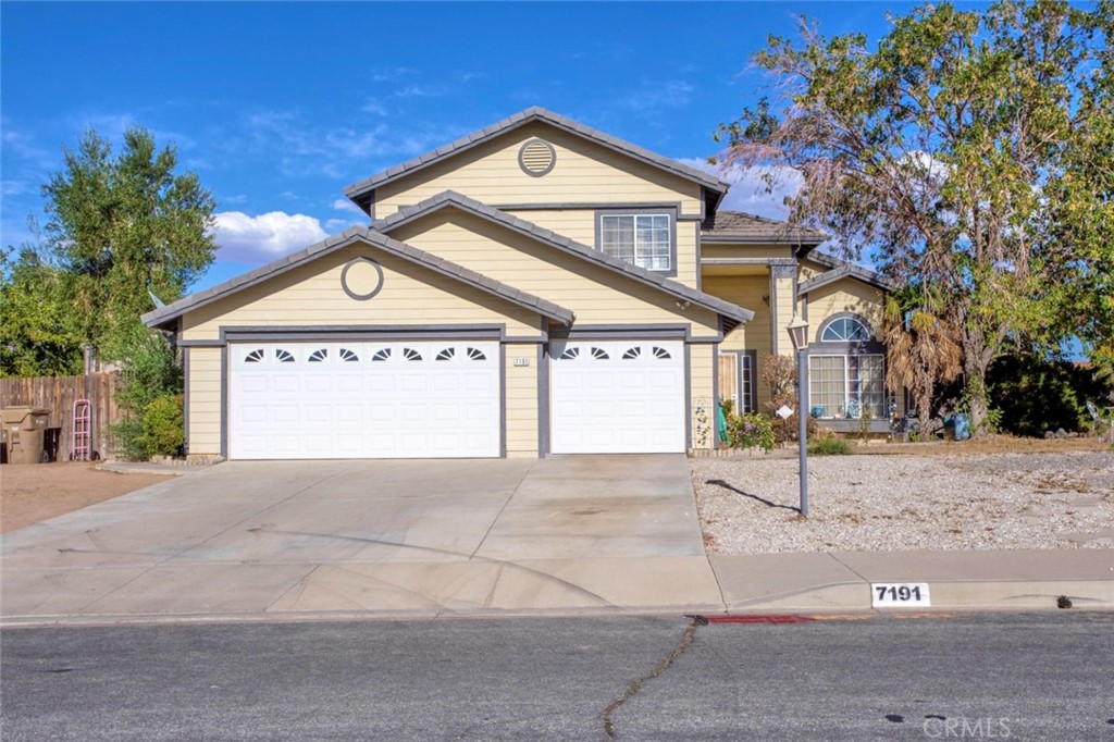 7191 Hawthorne Road Hesperia, CA 92345 - Photo 1 of 1 a front view of a house with a yard and garage