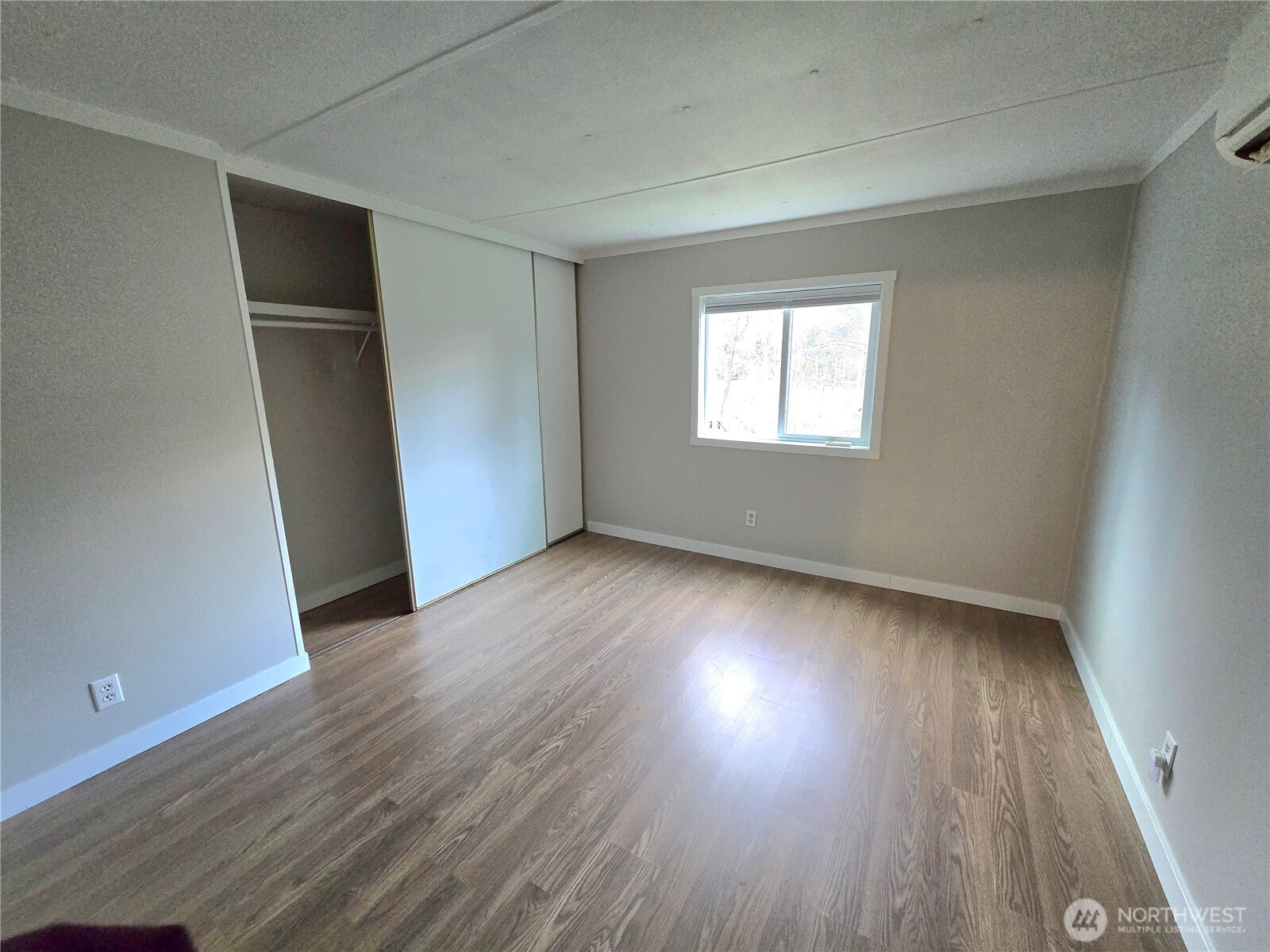 212 Old Owen Road, Unit 43 Sultan, WA 98294 - Photo 15 of 19 an empty room with wooden floor and windows