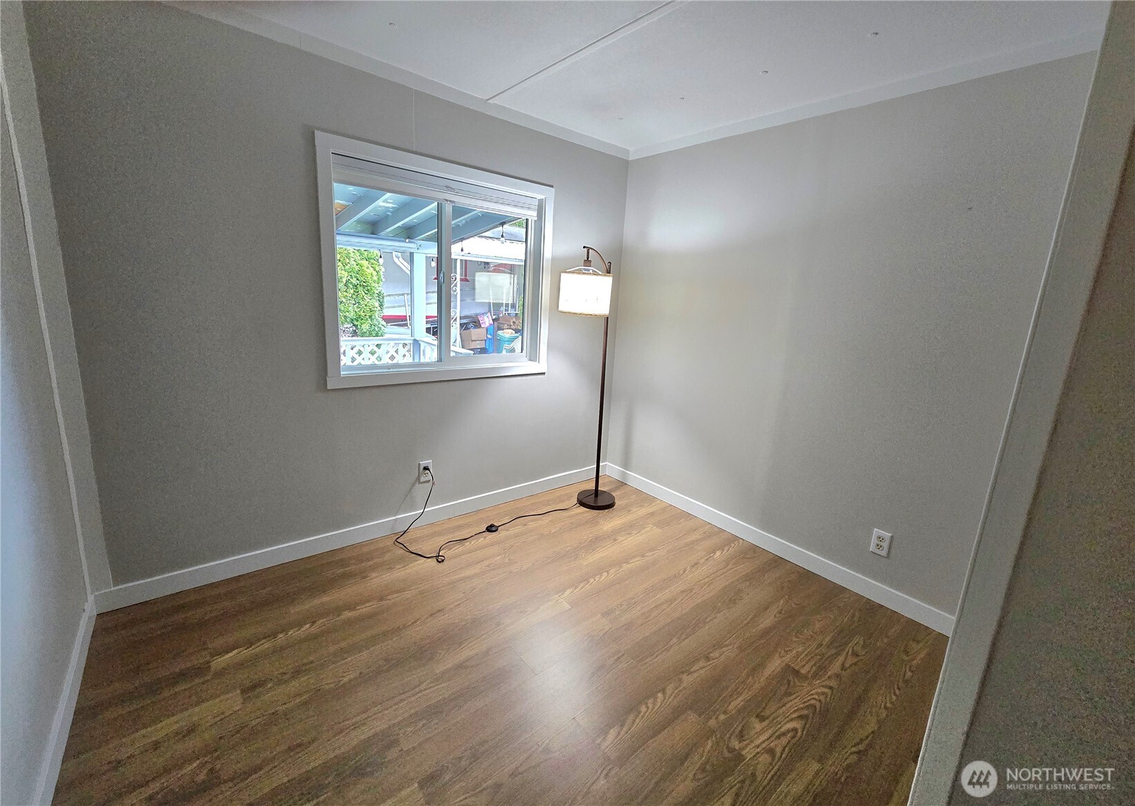 212 Old Owen Road, Unit 43 Sultan, WA 98294 - Photo 16 of 19 an empty room with wooden floor and windows