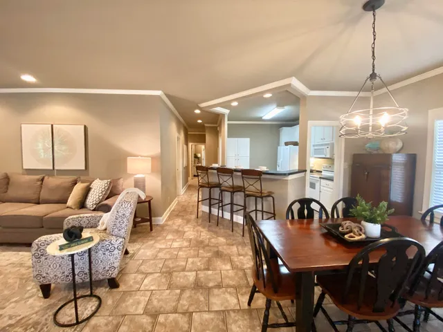 a view of a dining room and livingroom with furniture