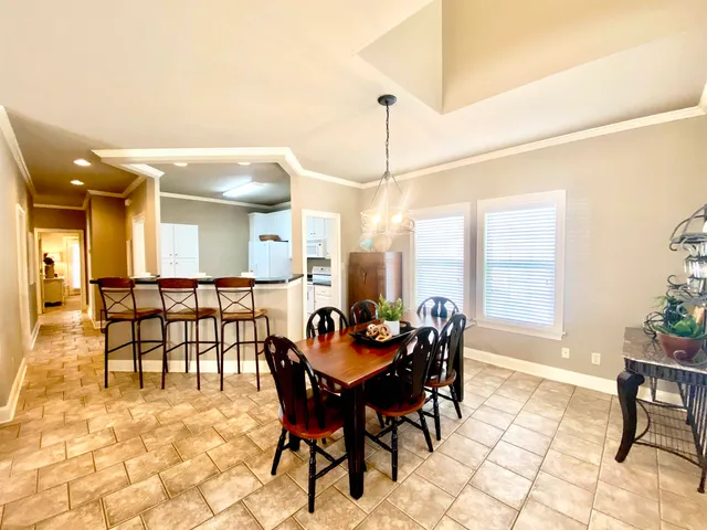 a dining room with furniture and window