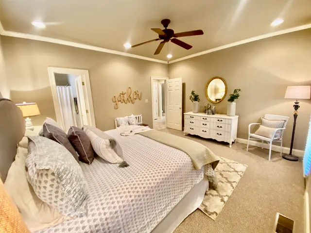 a bedroom with a bed and a chandelier