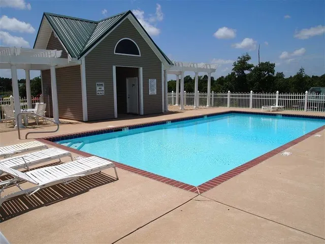 a view of swimming pool with lounge chair