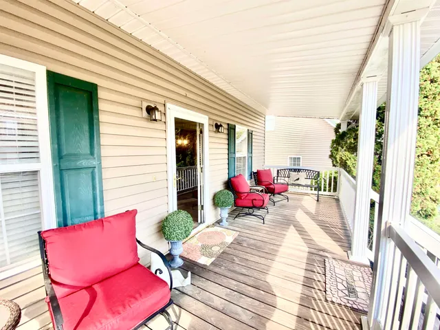 a view of a patio with couches chairs and potted plants