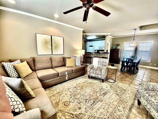 a living room with furniture and wooden floor