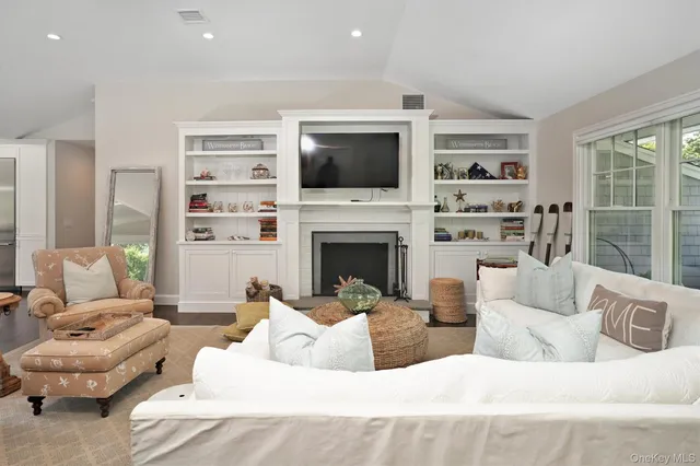 a living room with furniture fireplace and a flat screen tv