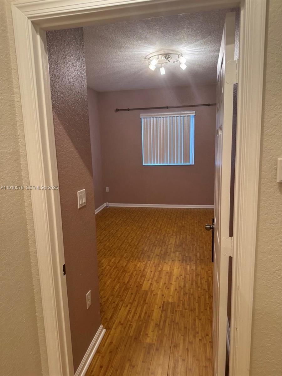 5753 Isles Circle Tamarac, FL 33321 - Photo 8 of 13 a view of empty room with wooden floor