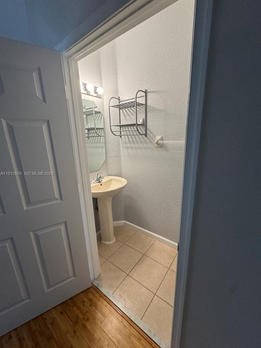 5753 Isles Circle Tamarac, FL 33321 - Photo 9 of 13 a bathroom with a sink and toilet
