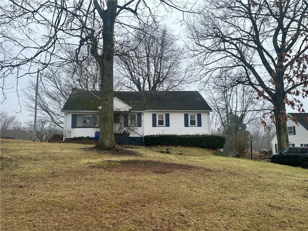3511 Church Road New Castle, PA 16101 - Photo 2 of 6 a front view of a house with a yard covered with trees