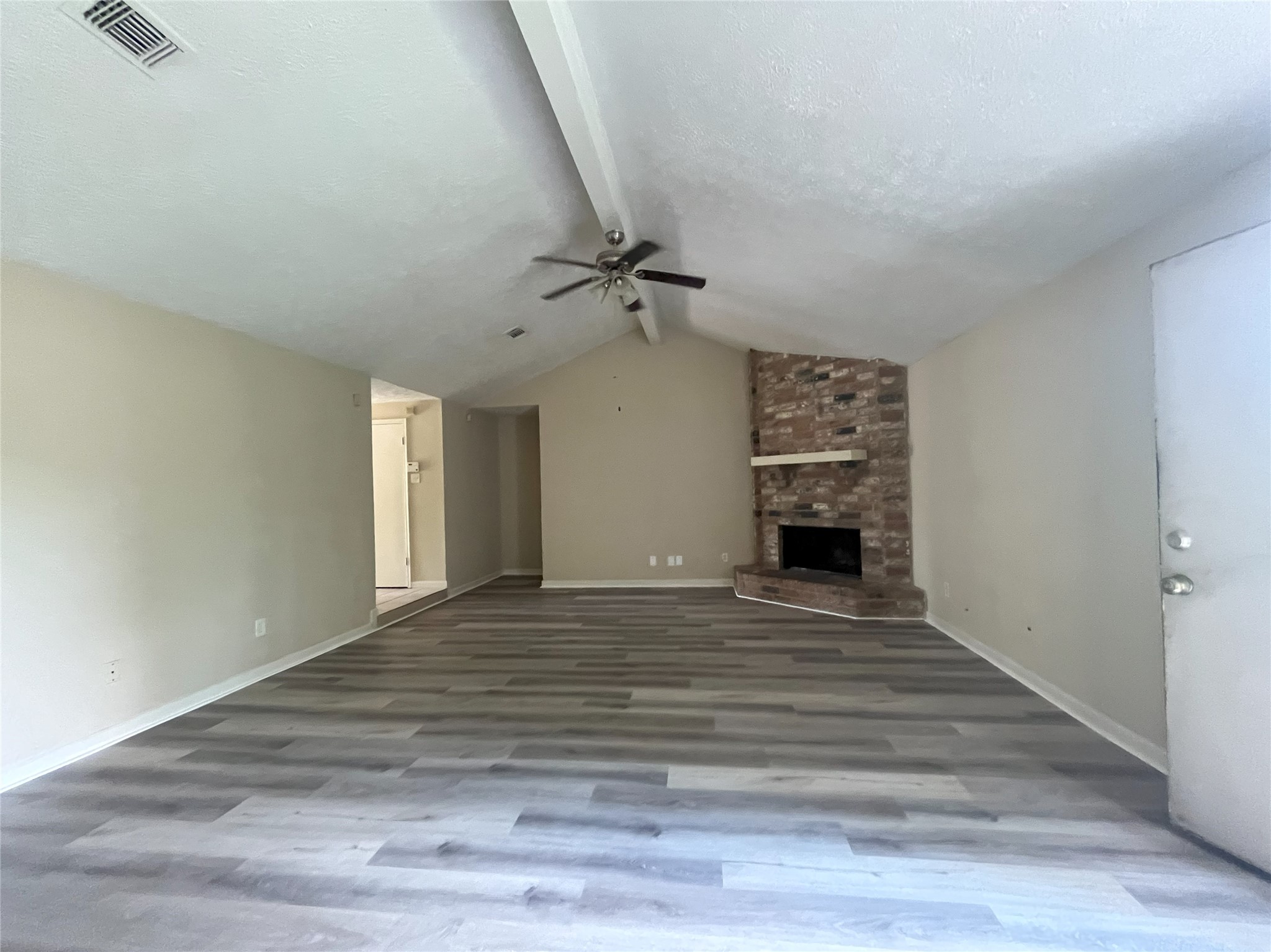 14874 Easingwold Drive Houston, TX 77015 - Photo 3 of 13 a view of a livingroom with a fireplace a ceiling fan and wooden floor