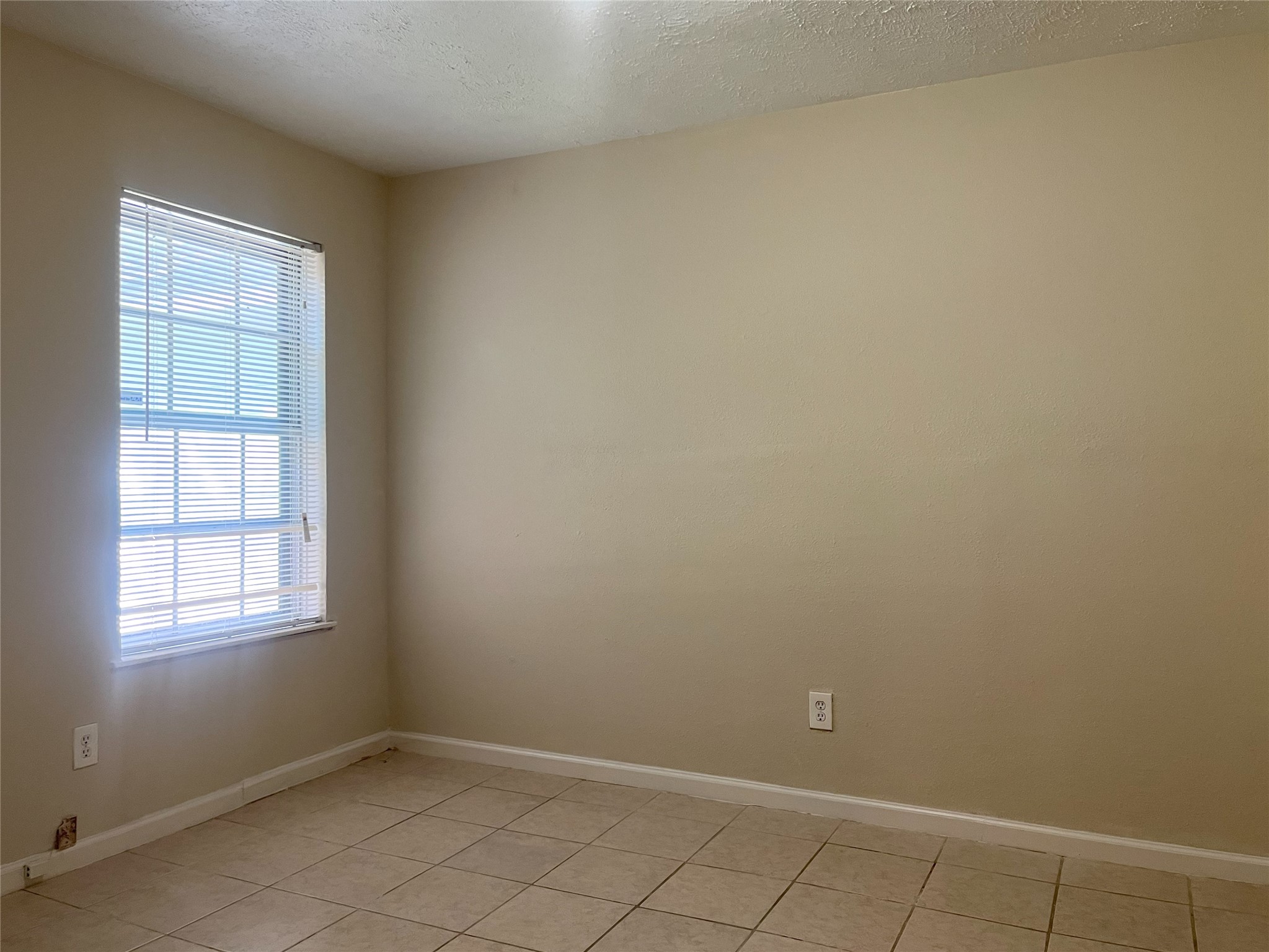 14874 Easingwold Drive Houston, TX 77015 - Photo 10 of 13 an empty room with windows