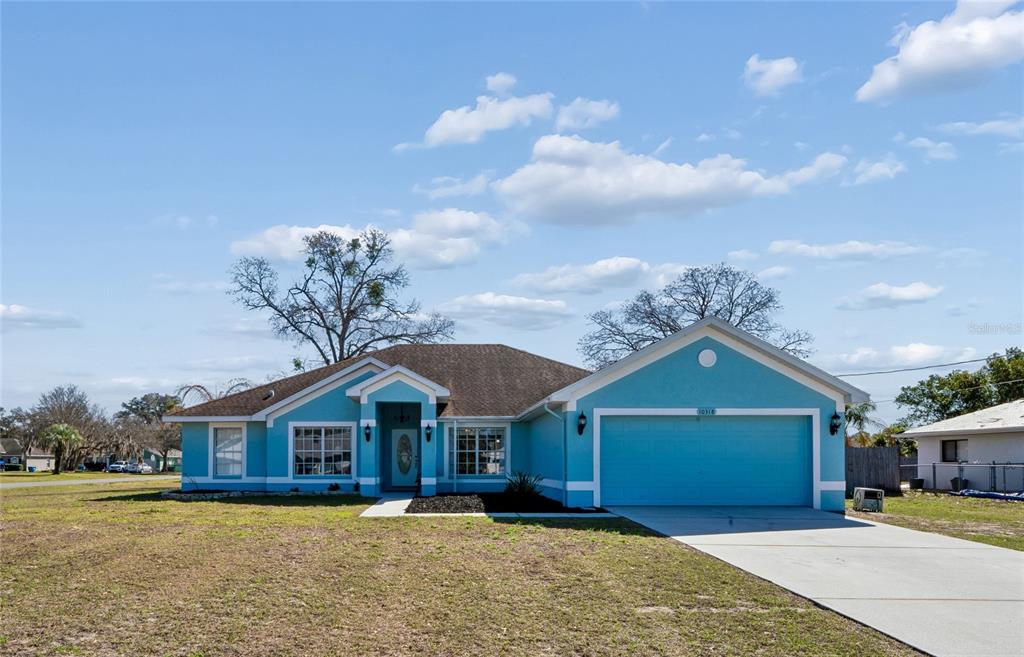 10318 Gifford Drive Spring Hill, FL 34608 - Photo 11 of 57 a front view of a house with a yard and garage