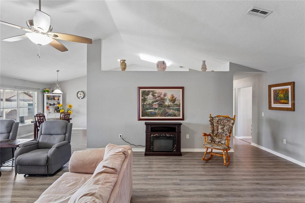 10318 Gifford Drive Spring Hill, FL 34608 - Photo 12 of 57 a living room with furniture and a fireplace