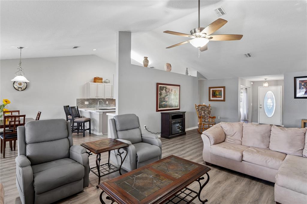 10318 Gifford Drive Spring Hill, FL 34608 - Photo 14 of 57 a living room with furniture kitchen view and a chandelier