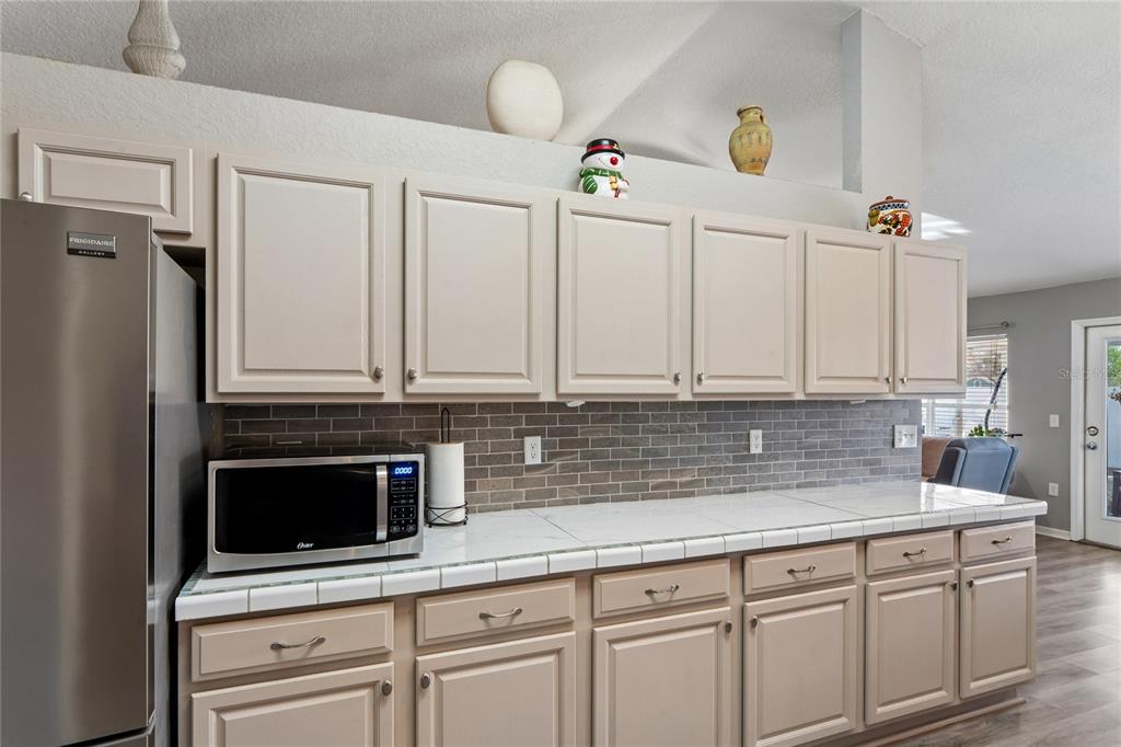 10318 Gifford Drive Spring Hill, FL 34608 - Photo 2 of 57 a kitchen with granite countertop a sink and cabinets