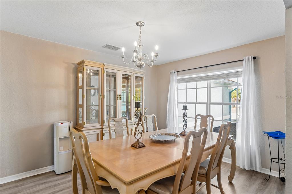 10318 Gifford Drive Spring Hill, FL 34608 - Photo 21 of 57 a view of a dining room with furniture window and wooden floor