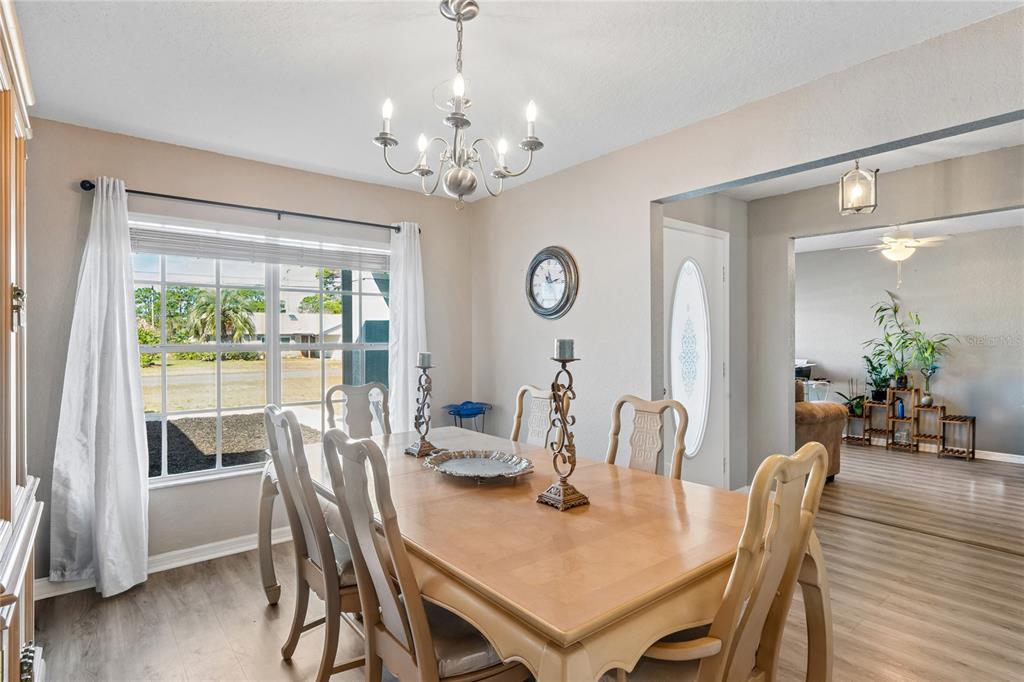 10318 Gifford Drive Spring Hill, FL 34608 - Photo 22 of 57 a view of a dining room with furniture window and wooden floor