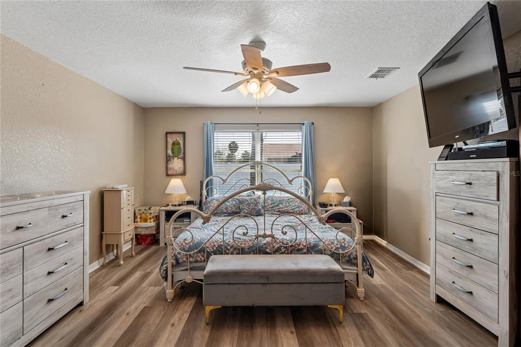 10318 Gifford Drive Spring Hill, FL 34608 - Photo 25 of 57 a bedroom with a bed and a flat screen tv