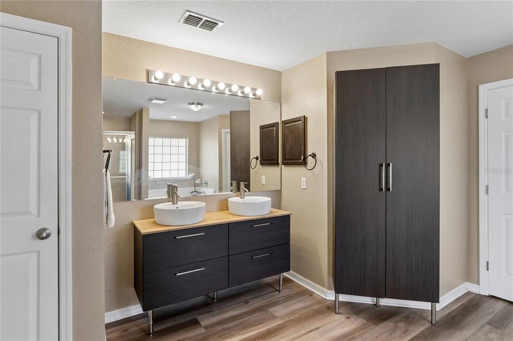10318 Gifford Drive Spring Hill, FL 34608 - Photo 27 of 57 a bathroom with a double vanity sink and a mirror