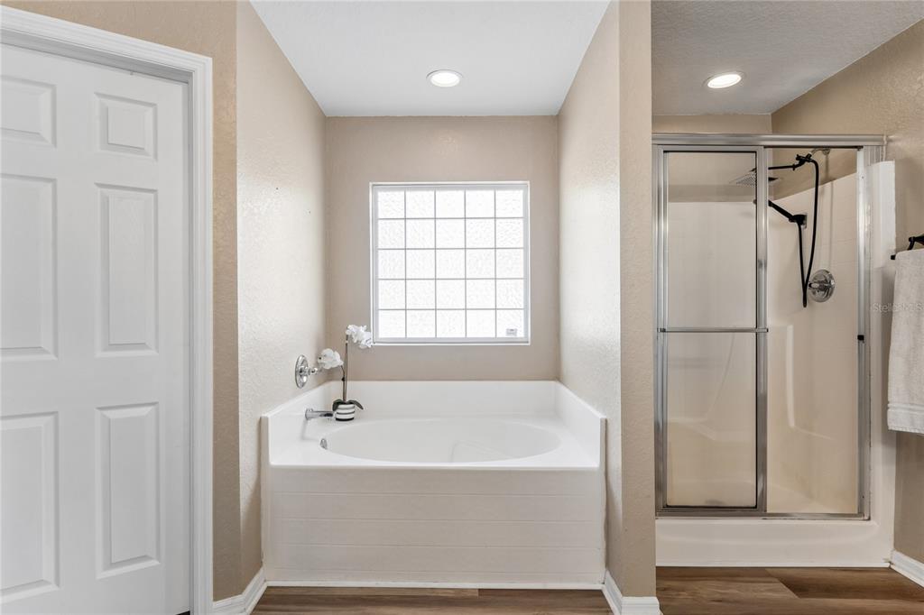 10318 Gifford Drive Spring Hill, FL 34608 - Photo 28 of 57 a bathroom with a bathtub and a shower