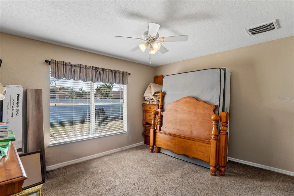 10318 Gifford Drive Spring Hill, FL 34608 - Photo 34 of 57 a bedroom with a bed and a window