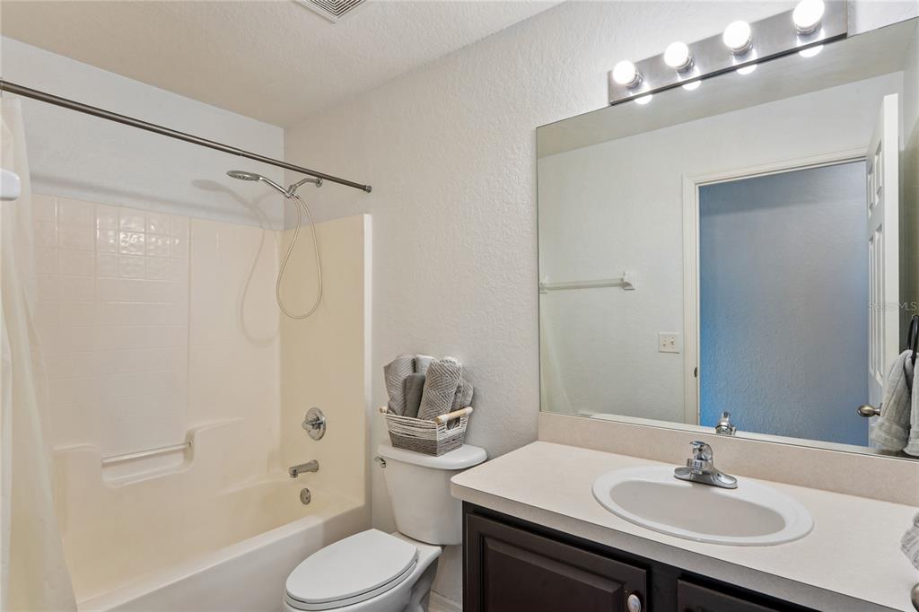 10318 Gifford Drive Spring Hill, FL 34608 - Photo 36 of 57 a bathroom with a sink toilet a shower and a mirror