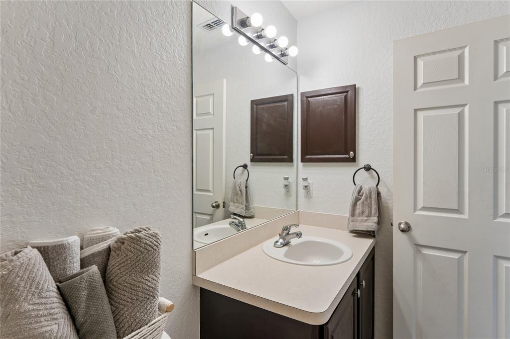 10318 Gifford Drive Spring Hill, FL 34608 - Photo 37 of 57 a bathroom with a sink and a mirror