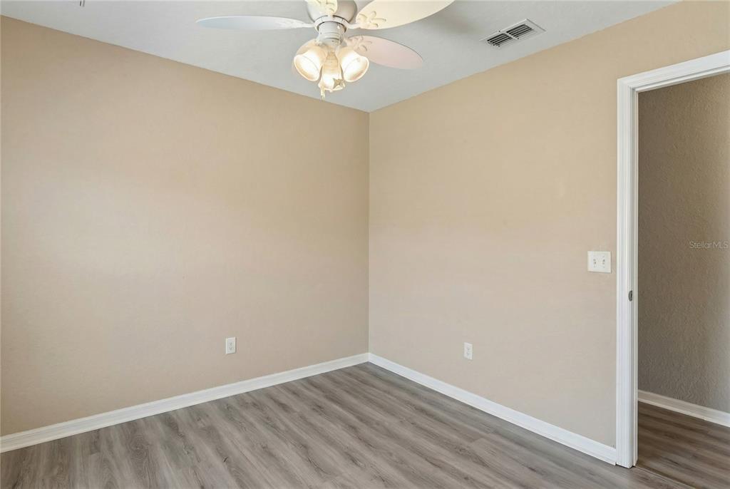 10318 Gifford Drive Spring Hill, FL 34608 - Photo 39 of 57 an empty room with a wooden floor and a window